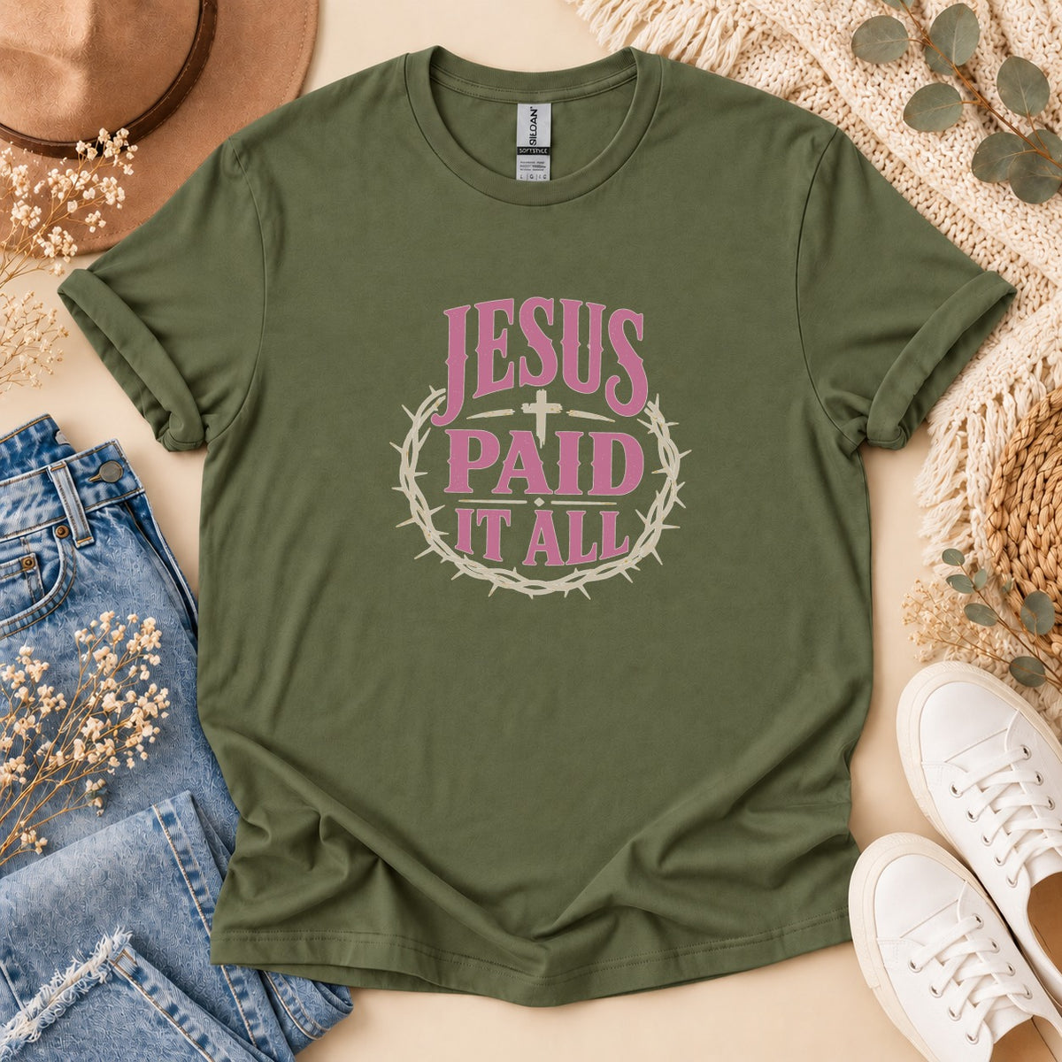 Olive green t-shirt with "JESUS PAID IT ALL" in pink text and a crown of thorns.