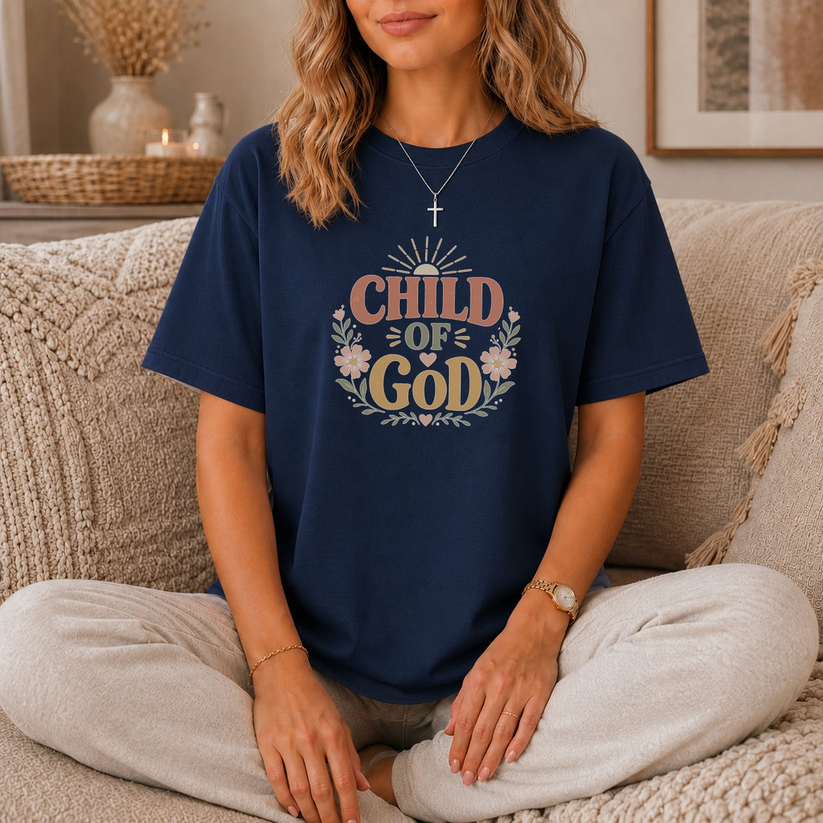 Navy t-shirt with "Child of God" text design and floral wreath.