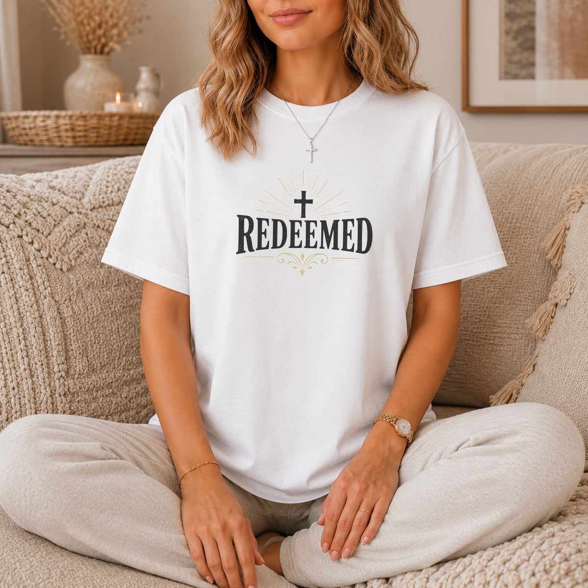 White t-shirt with "Redeemed" and a cross graphic.