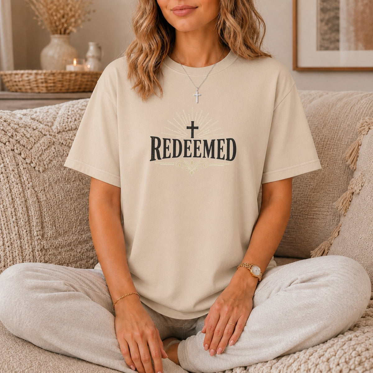 Tan t-shirt with "REDEEMED" text and a cross graphic.
