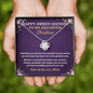 Hands holding a Sweet Sixteen gift card with love knot necklace for daughter