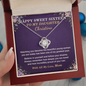Hand holding a Sweet 16 love knot necklace in its gift box with a card from Mom