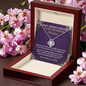 Sweet 16 love knot necklace in luxury gift box surrounded by pink flowers