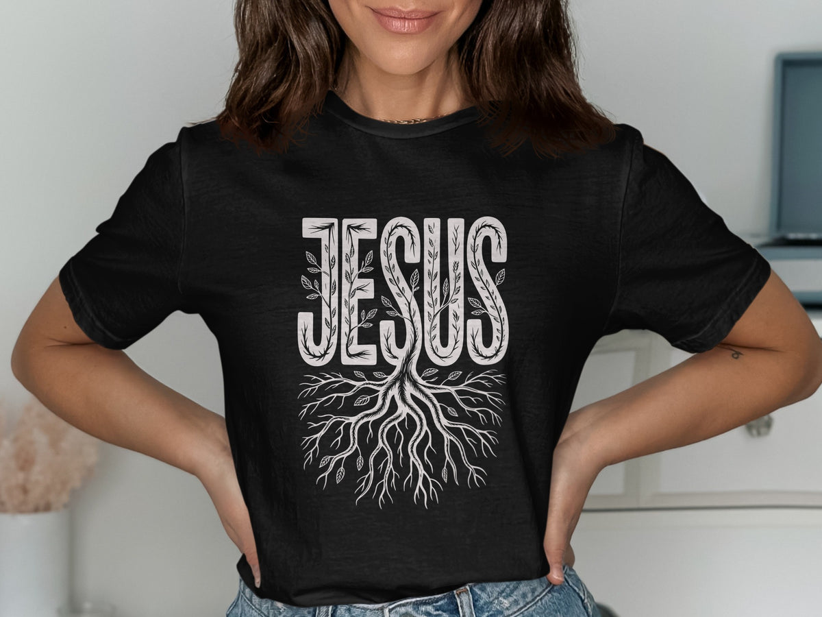 Black t-shirt with the word JESUS in a decorative font and tree roots.