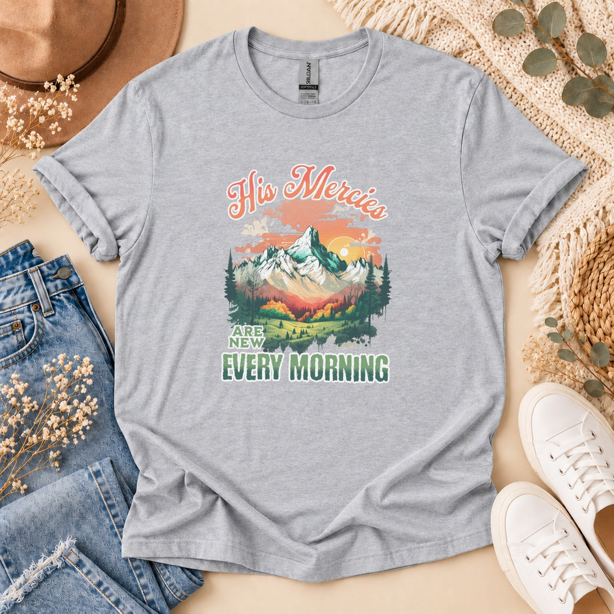 Grey t-shirt with "His Mercies Are New Every Morning" text and mountain landscape design.