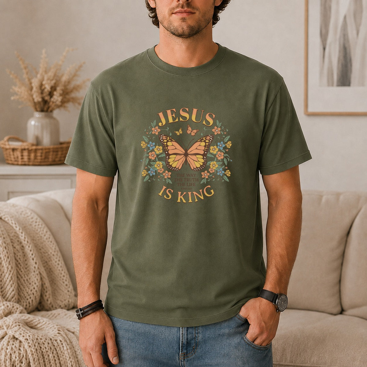 Olive green t-shirt with a butterfly, flowers, and text "JESUS IS KING".