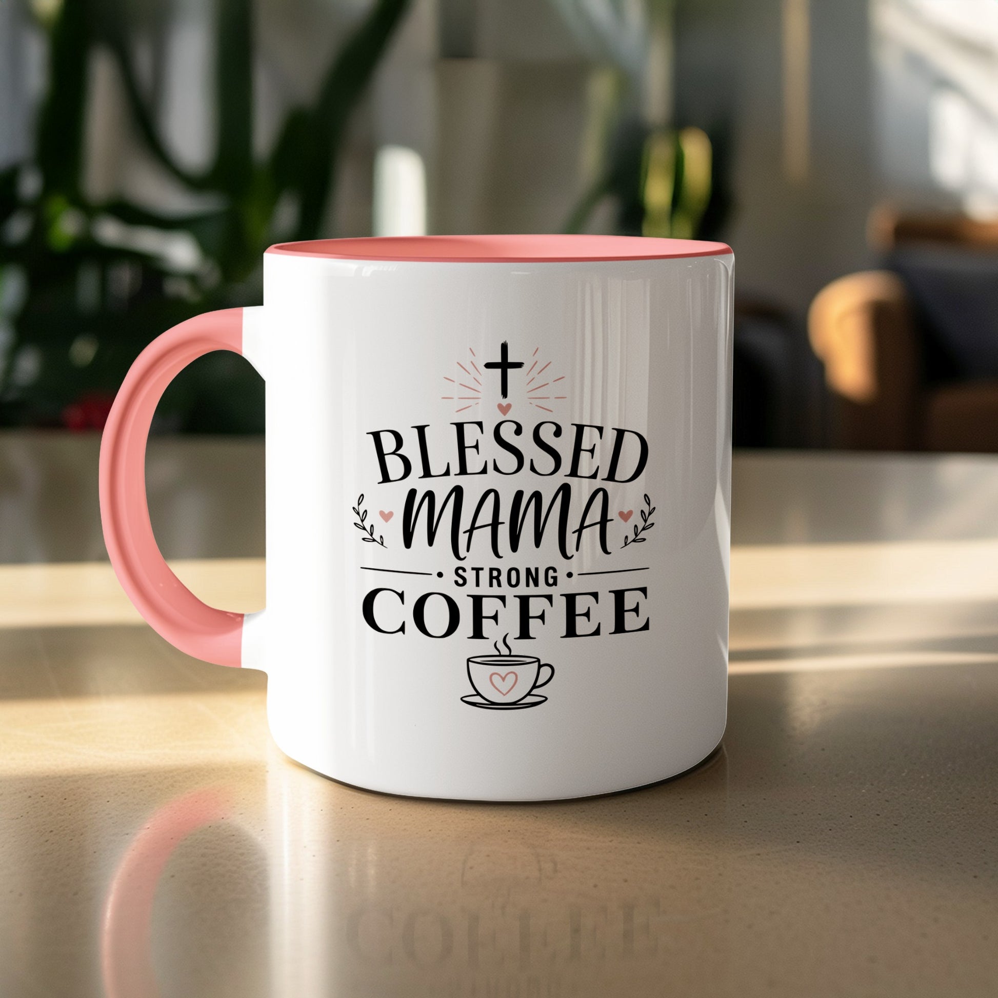 White coffee mug with pink handle, "Blessed Mama Strong Coffee" text and heart design.