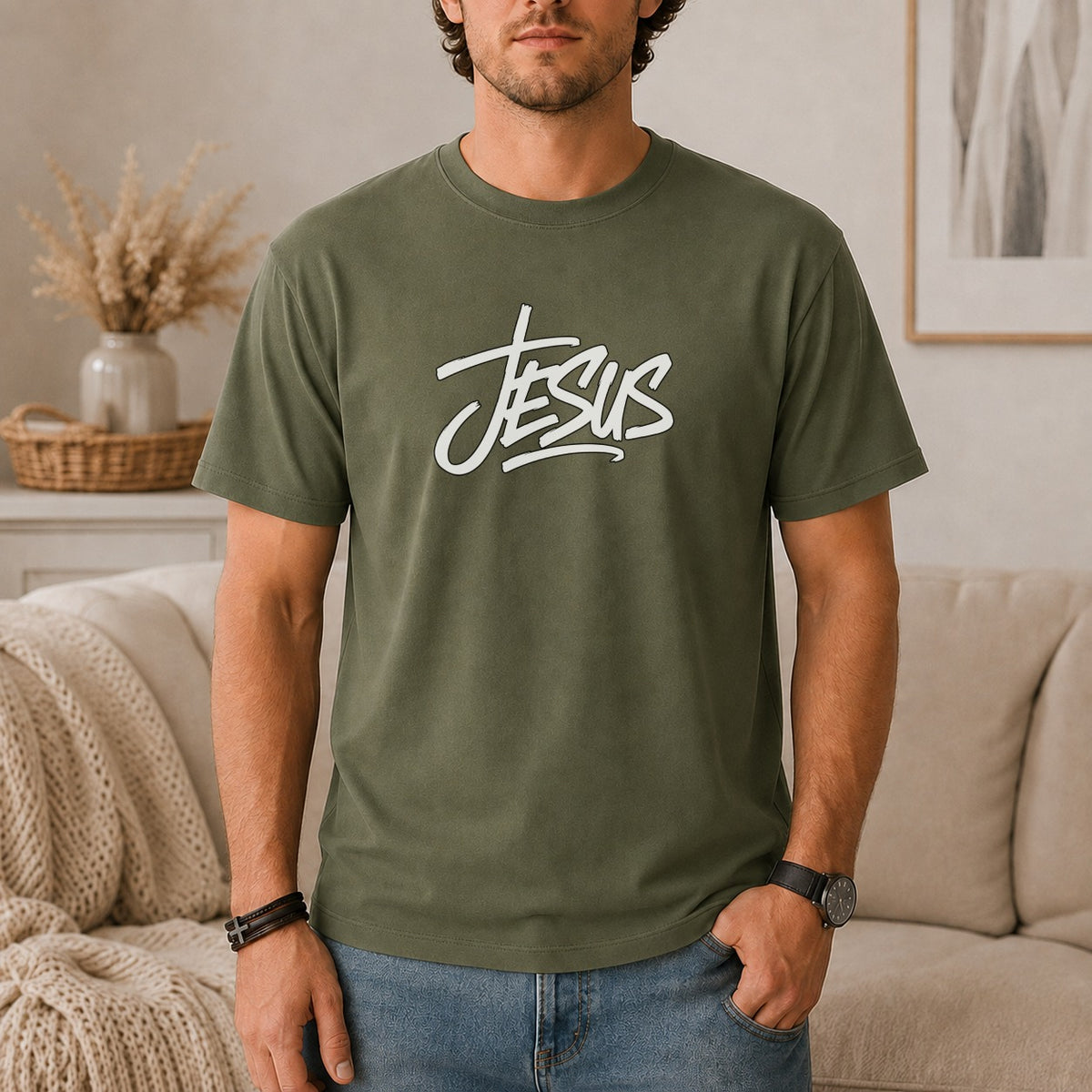 Olive green t-shirt with white "Jesus" script graphic worn by a man.