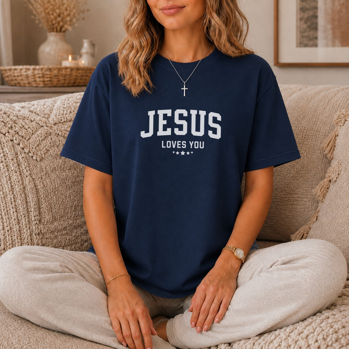 Navy t-shirt with "JESUS LOVES YOU" printed in white lettering and three stars.