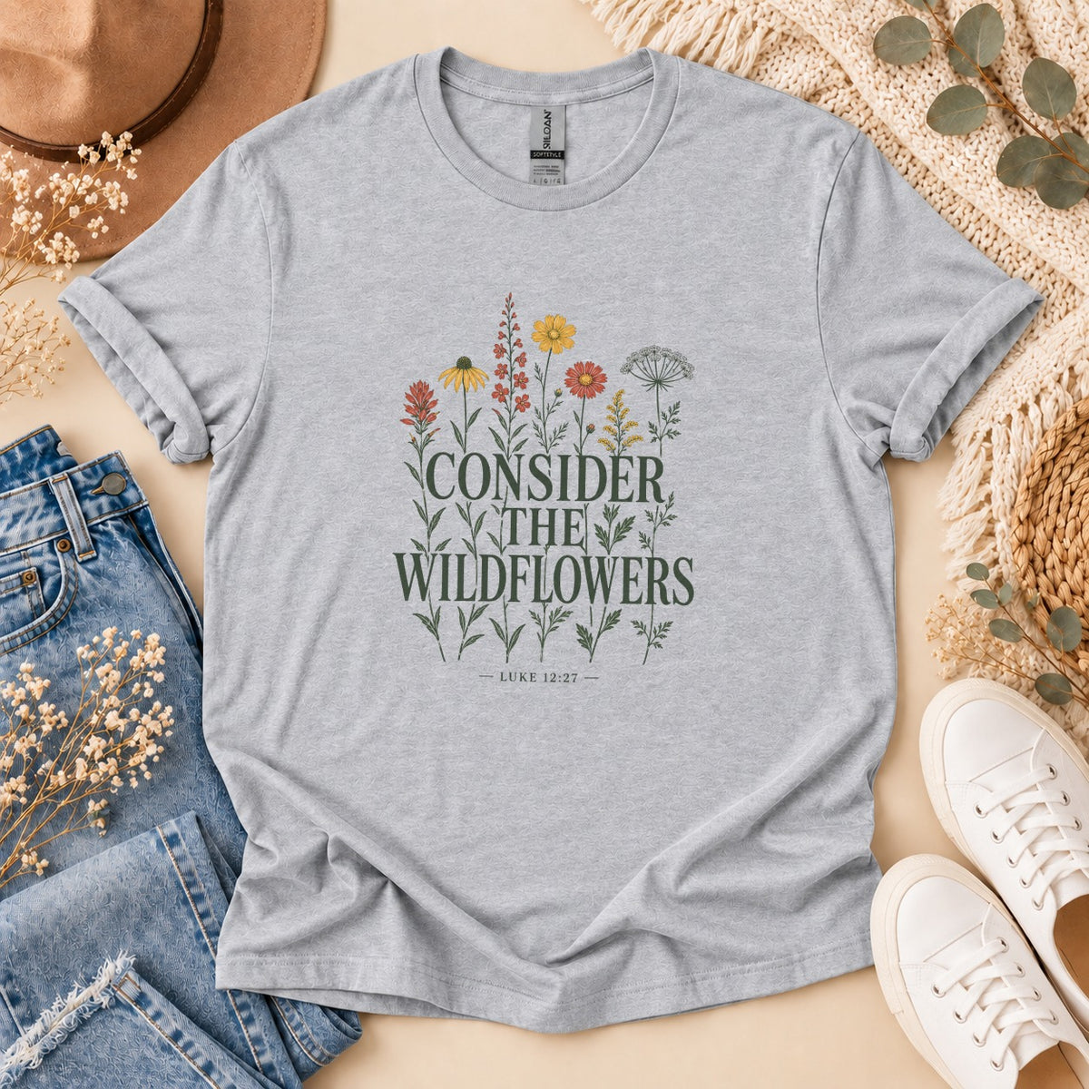 Grey t-shirt with "CONSIDER THE WILDFLOWERS" and "LUKE 12:27" text and floral graphics.