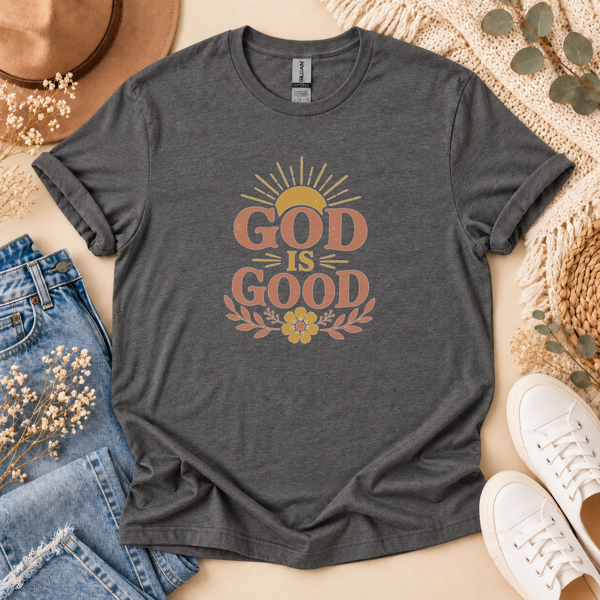 Dark grey t-shirt with "God Is Good" text and sunburst graphic.