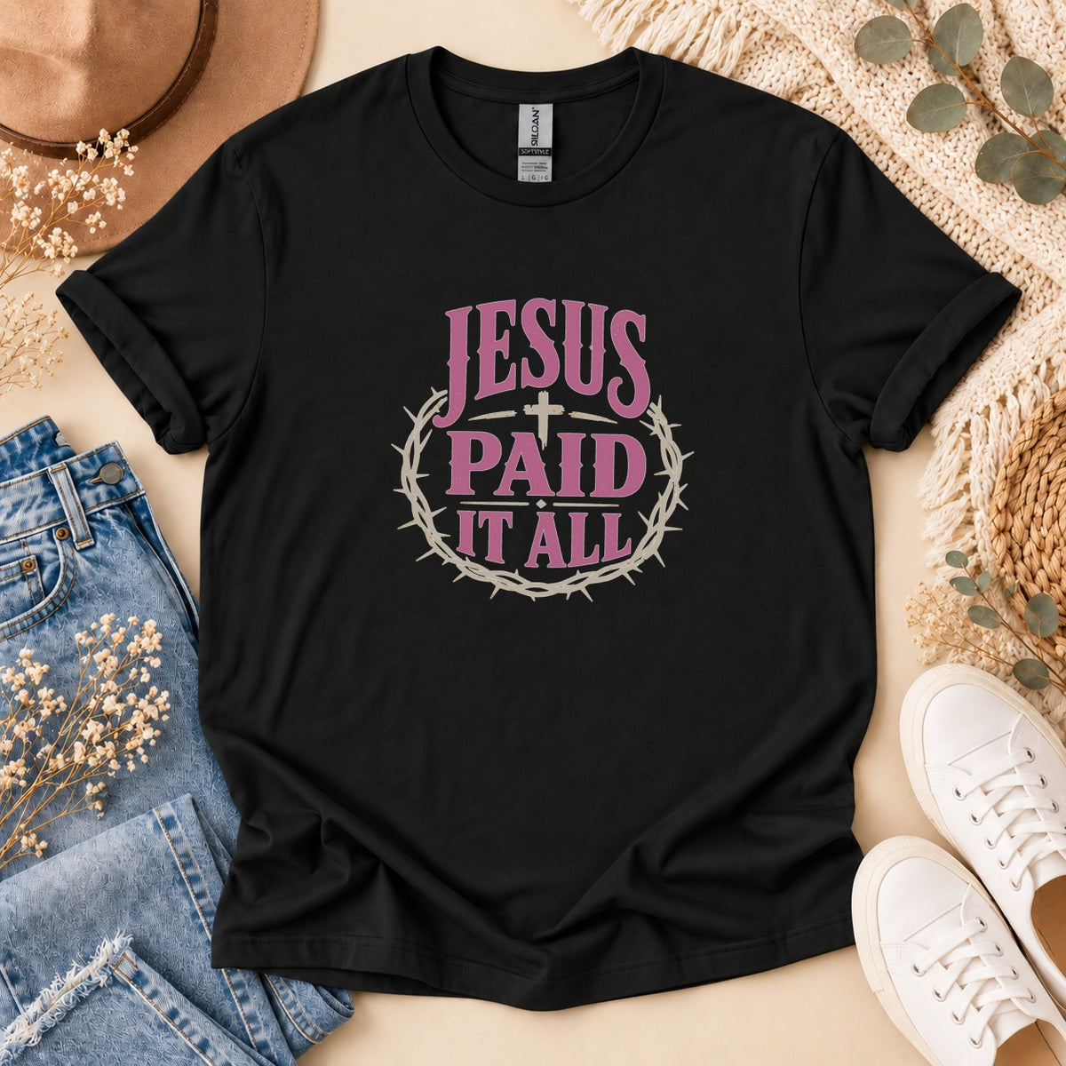 Black t-shirt with pink text "JESUS PAID IT ALL" inside a crown of thorns.