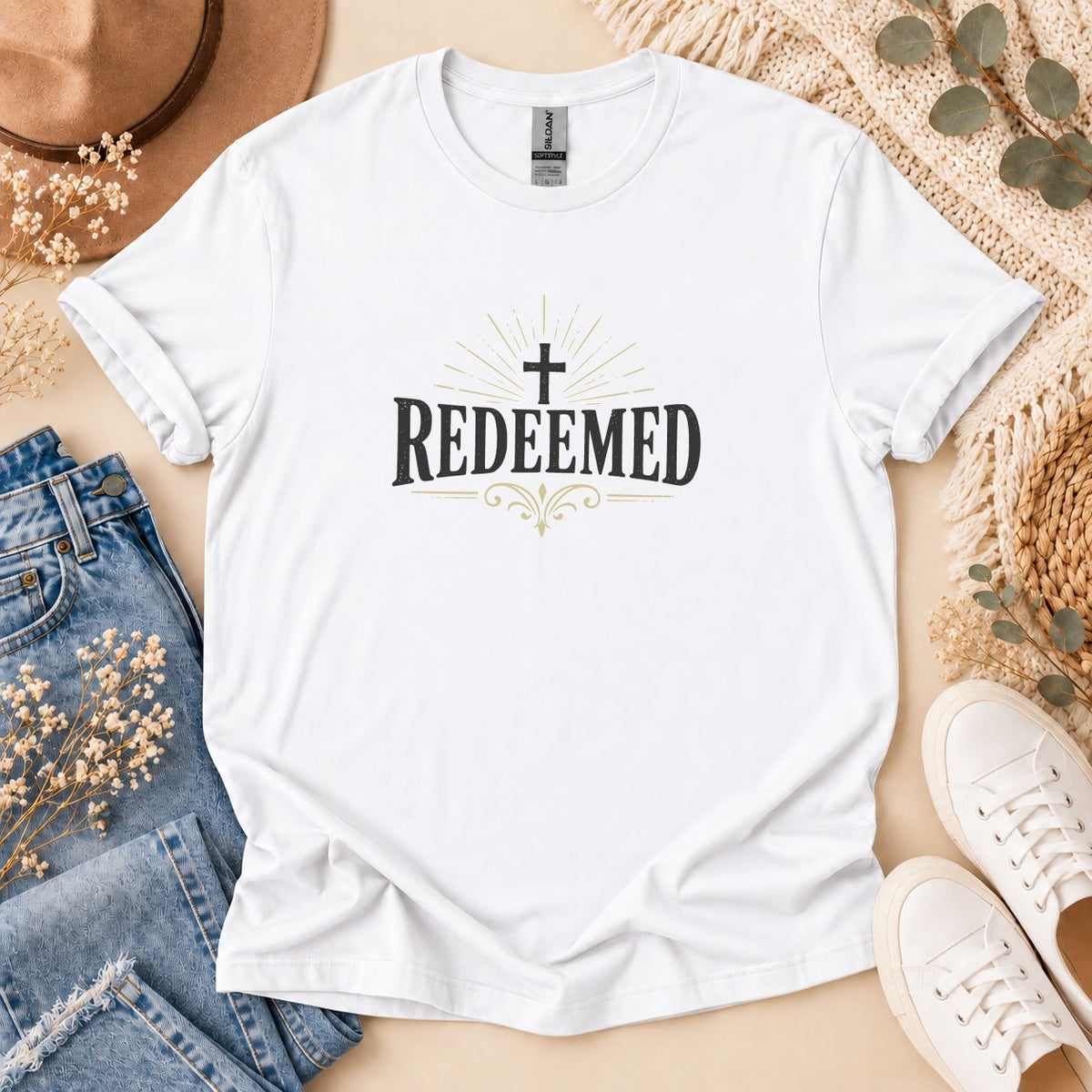 White t-shirt with "Redeemed" and a cross graphic.