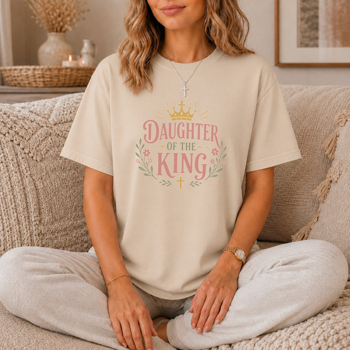 Tan t-shirt with "Daughter of the King" text, crown, and floral design.