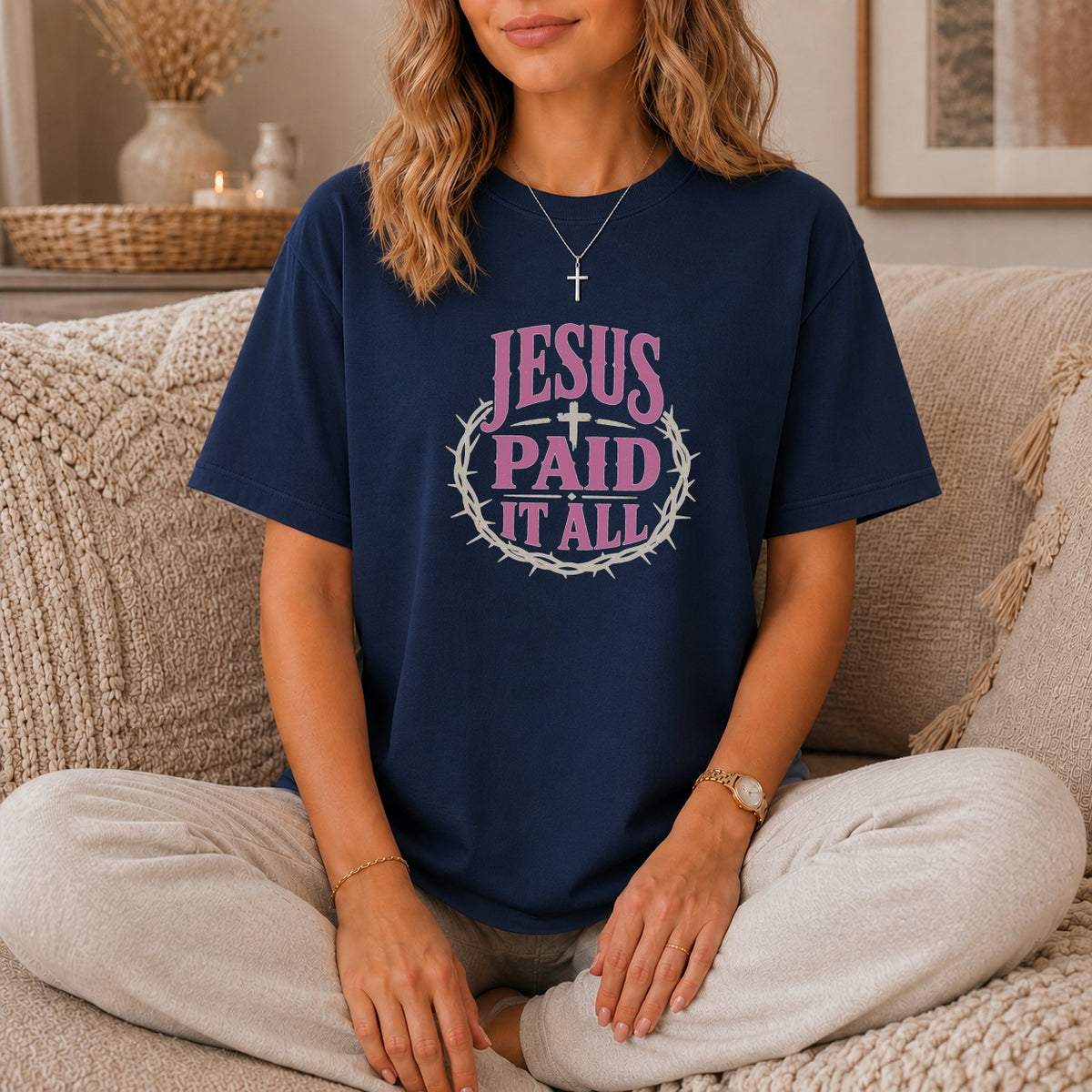 Navy t-shirt with pink text "JESUS PAID IT ALL" and a cross in a crown of thorns.