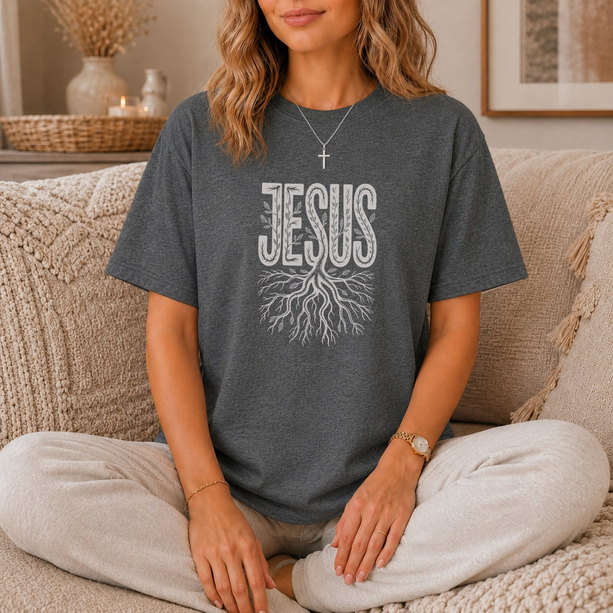 Dark gray t-shirt with white "JESUS" text and tree root graphic.