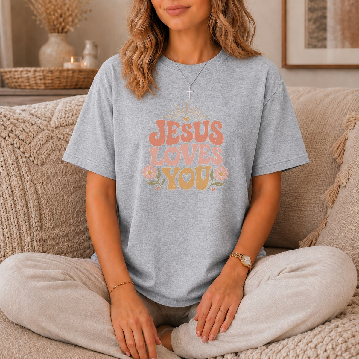 Grey t-shirt with "JESUS LOVES YOU" graphic and floral accents.