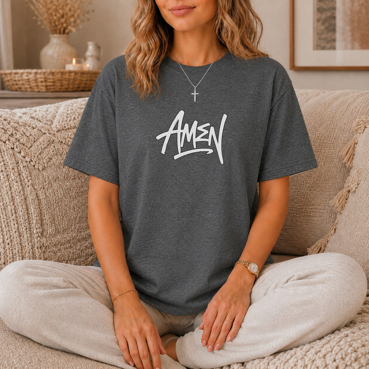 Charcoal t-shirt with white "AMEN" graphic, worn by a person sitting cross-legged.